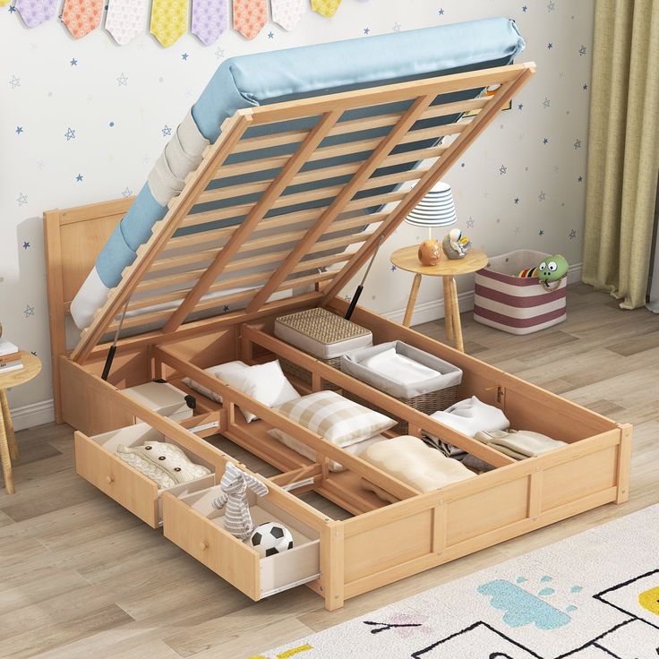 a wooden bed with drawers underneath it on the floor in a child's room