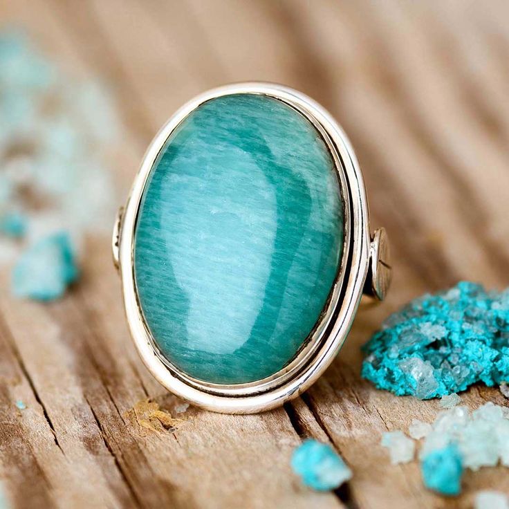 Large Amazonite stone ring Made of sterling silver and genuine natural gemstone. Simple yet unique.*Our jewelry features natural, genuine gemstones, ensuring each piece is unique and one-of-a-kind. Please note that, as no two gemstones are identical, the jewelry you receive may vary from the photos.Material: Genuine Sterling Silver 92.5Gemstone: AmazoniteGemstone size: 23x16mmRing size: Choose your sizeLength/wide: 25mmCondition: Brand new Amazonite Ring, Moonstone Ring Sterling Silver, Amazonite Stone, Beautiful Rainbow, Ring Sterling Silver, Stone Ring, Rainbow Moonstone, Sterling Ring, Stone Rings