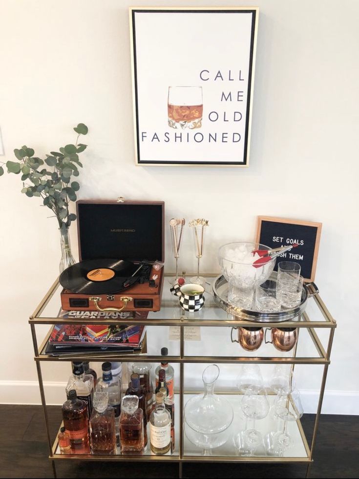 a bar cart filled with liquor bottles and glasses