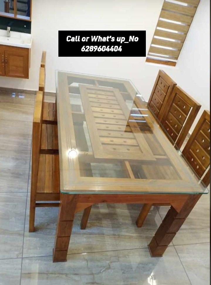 a glass table with wooden chairs around it