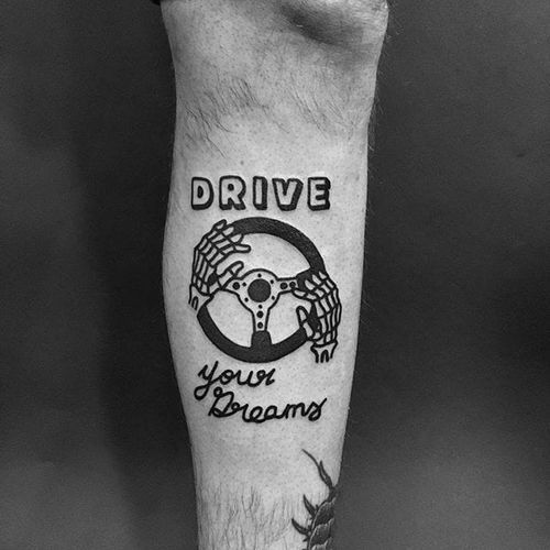 a black and white photo of a man's arm with a tattoo on it