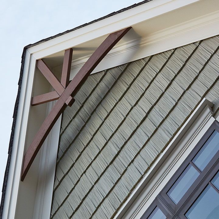 a wooden cross on the side of a building