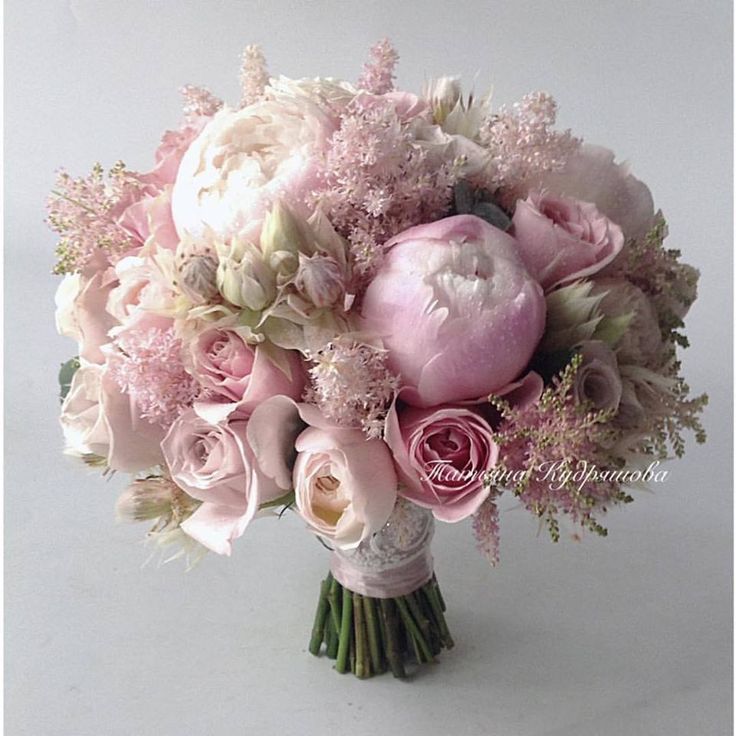 a bouquet of pink and white flowers on a table