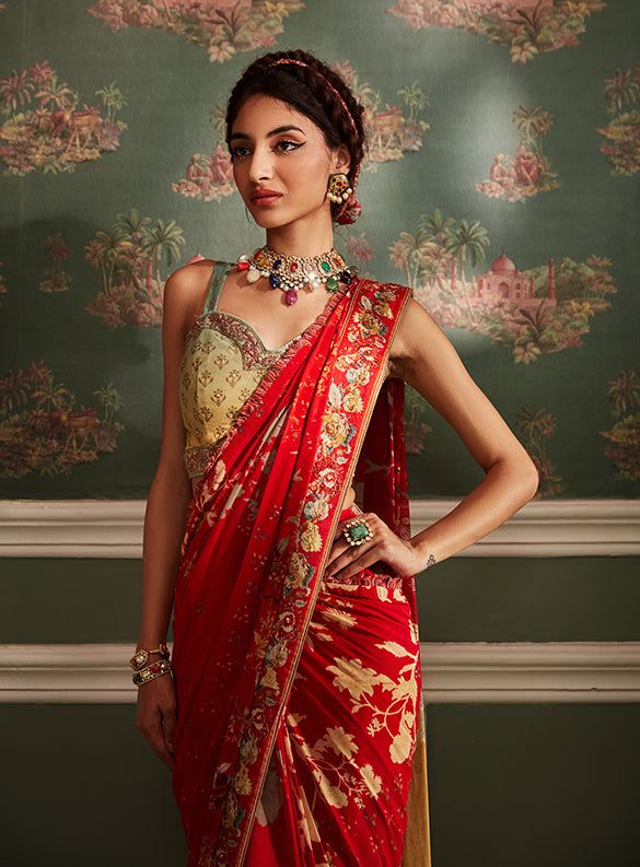 Editor's Note Featuring a pre-draped saree with elaborate overall floral print. It is styled with a sleeveless blouse intricately embellished with beads and sequins. Fabric: Viscose silk and viscose georgette Color: Red, multicolor Components: Sari and blouse Occasion: Wedding Guest and festive Disclaimer: Product color may slightly vary due to photographic lighting sources or your monitor setting. Care: Dry Clean Only About the Designer Kalista is a luxury fashion label that specializes in desi Brocade Saree, Drape Saree, Red Saree, Embroidered Wedding, Wedding Saree, Silk Organza, Fashion Heels, Saree With Blouse, Red Silk