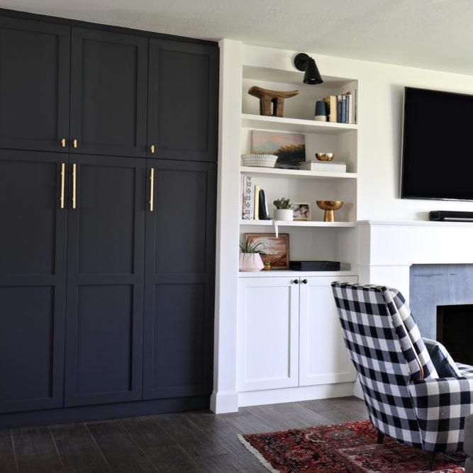 a living room filled with furniture and a flat screen tv mounted on a wall above a fireplace