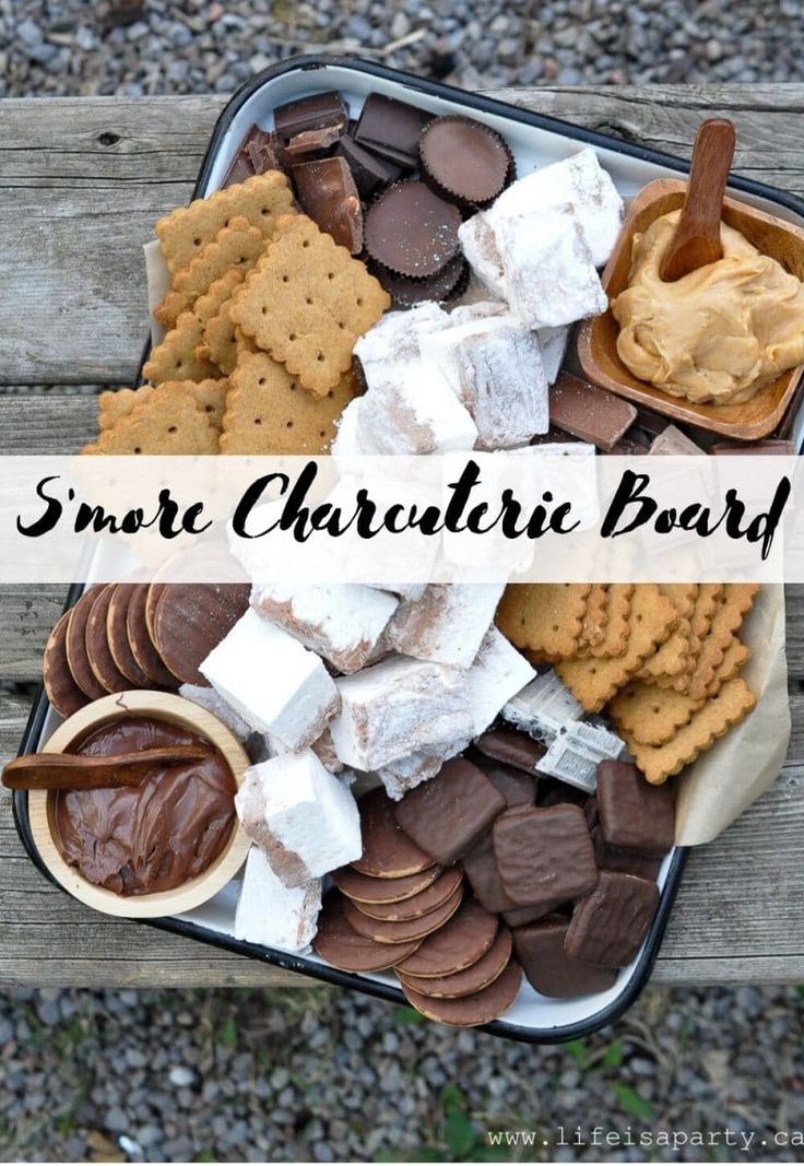 an assortment of cookies and marshmallows in a tin with the words, smart charlotte board