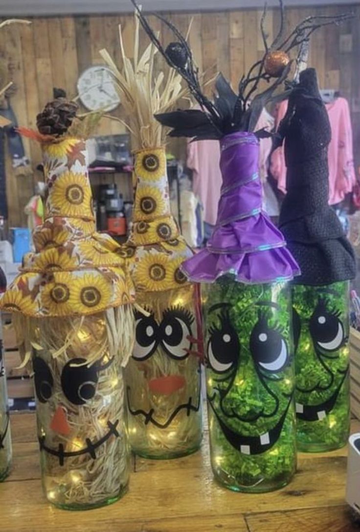 several decorated vases sitting on top of a wooden table