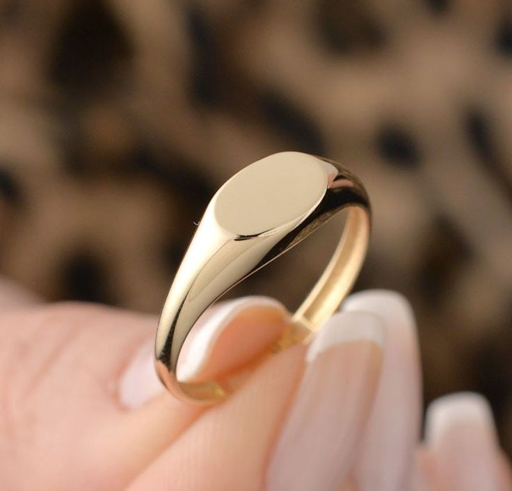 Our oval ring is made of 14k solid gold. It fits your all outfit at any time of the day with its minimalist and dainty style. Also, it can be used as a joint ring. You can enter the name, initial, date, or whatever you want on the personalization box. Your name is engraved with a special laser. ( You can see the example of a ring that is engraved with a special laser on the photos.) If you consider this gold ring as a gift for special days, it will an excellent choice for your loved ones on thei Gold Oval Ring, Ring Name, Dainty Style, Name Ring, Name Rings, Personalized Ring, Solid Gold Ring, Emerald Pendant, Oval Ring