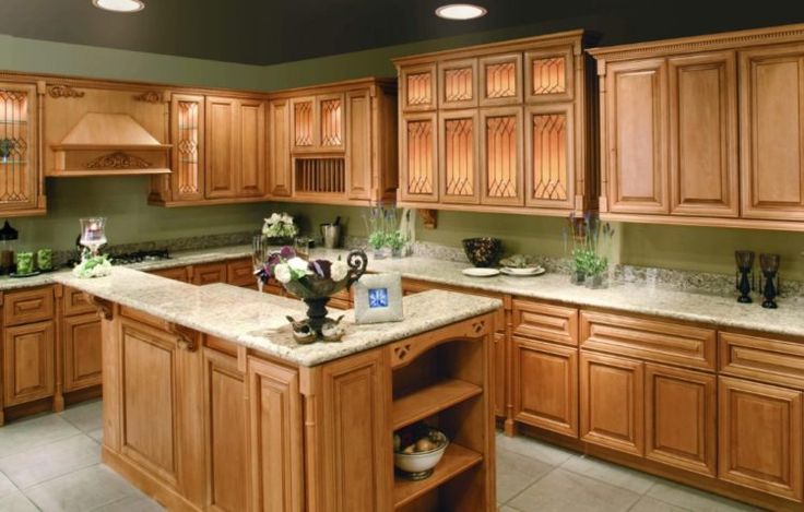 a kitchen filled with lots of wooden cabinets and counter top space next to an oven