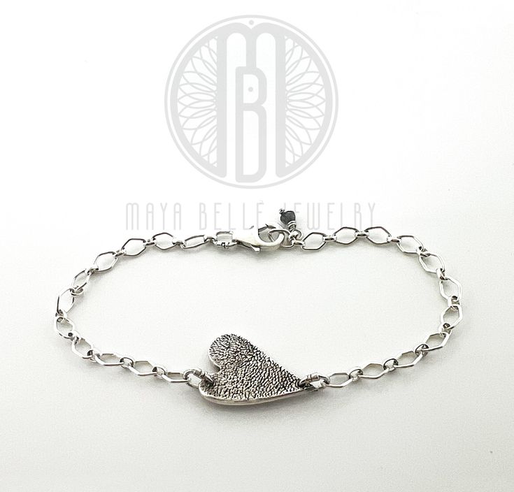 Eternally cherish your beloved pets with a timeless piece of jewelry featuring their paw print. Experience the true meaning of forever. Custom Paw Print bracelet. Available in silver or gold. Silver: fine silver charm with sterling silver chainGold: 22k charm with 14k gf chain *please email or text for pricing: daria@mayabellejewelry.com 215-527-1767HOW IT WORKS:* A mold kit, as well as a pre-paid return label, will be shipped to you right away. (same or next business day)* Create the mold with Sterling Silver White Gold Bracelet For Promise, Sterling Silver White Gold Promise Bracelet, Dainty Stamped Jewelry For Everyday, Minimalist Hand Stamped Promise Jewelry, Dainty Sterling Silver Charm Bracelet With Heart Charm, Silver Personalized Heart Bracelet, Classic Sterling Silver Charm Bracelet With Heart, Sterling Silver Heart Bracelet For Anniversary, Minimalist Silver Sterling Heart Bracelet