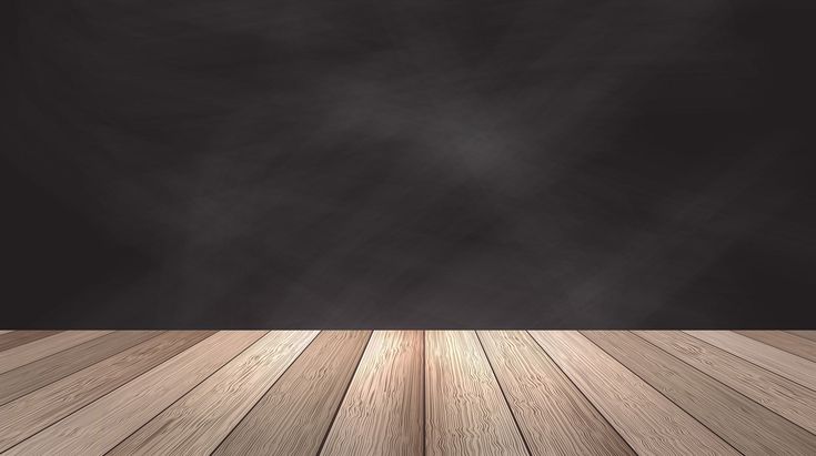 an empty room with wood floor and black wall