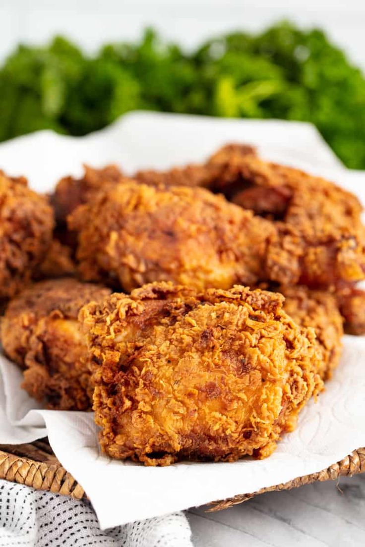 some fried food is on a white plate and next to green lettuce leaves