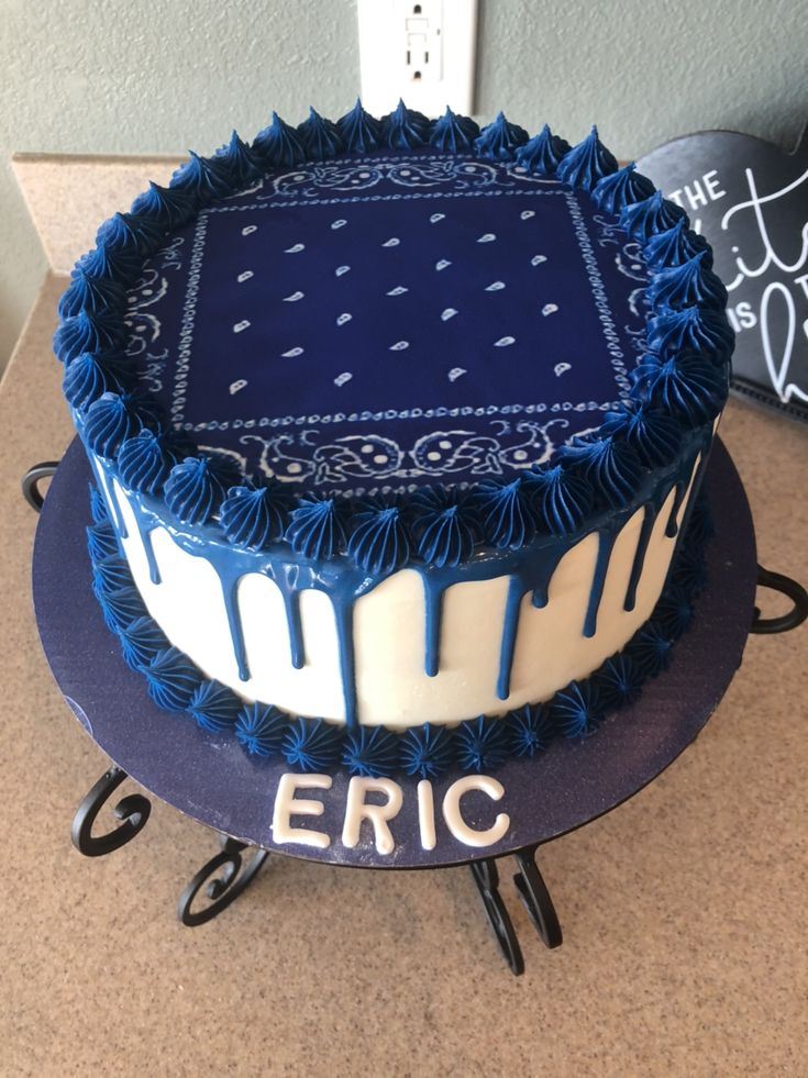 a blue and white cake sitting on top of a counter next to a sign that says eric