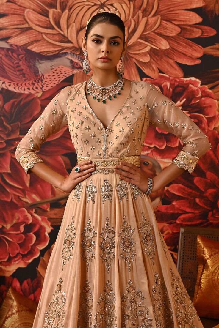 Blush pink zari brocade flared anarkali with plunged V neck, all over vintage pattern beads, thread, zari, sequin and cut dana embroidery. Paired with butterfly net dupatta with all over floral pattern and embroidered border.
Components: 2
Pattern: Embroidered
Type Of Work: Beads, Thread, Zari, Sequin and Cut Dana Work
Neckline: Plunged V Neck
Sleeve Type: Three Quarter Sleeves
Fabric: Anarkali: Zari Brocade, Pure Silk Organza, Dupatta- Butterfly Net
Color: Pink
Other Details: 
Scalloped cut wor Wedding Choli With Zari Work And V-neck, Festive Anarkali V-neck Gown, Festive Anarkali Gown With V-neck, Festive V-neck Salwar Kameez For Wedding, Traditional V-neck Party Gown, V-neck Wedding Gown For Eid, Anarkali Style Lehenga With V-neck And Resham Embroidery, Wedding Salwar Kameez Semi-stitched V-neck, Semi-stitched V-neck Salwar Kameez For Wedding