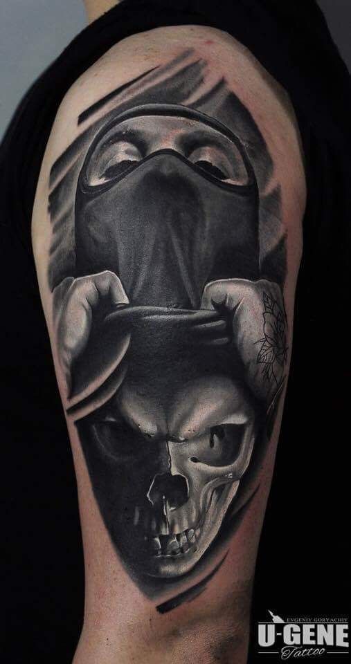 a man's arm with a skull and hat tattoo on the back of his shoulder