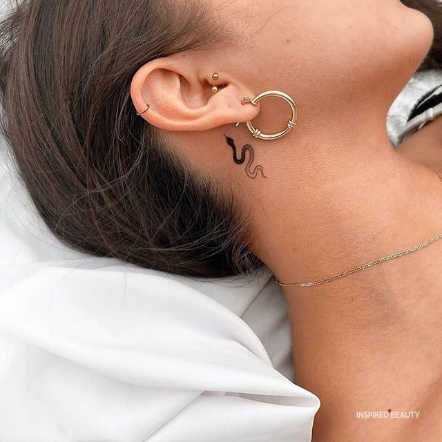 a woman with her ear piercings in the shape of numbers