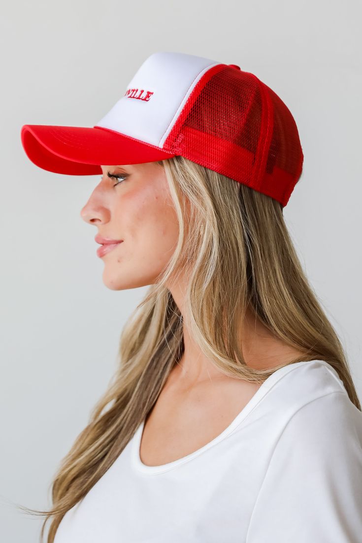 a woman wearing a red and white hat