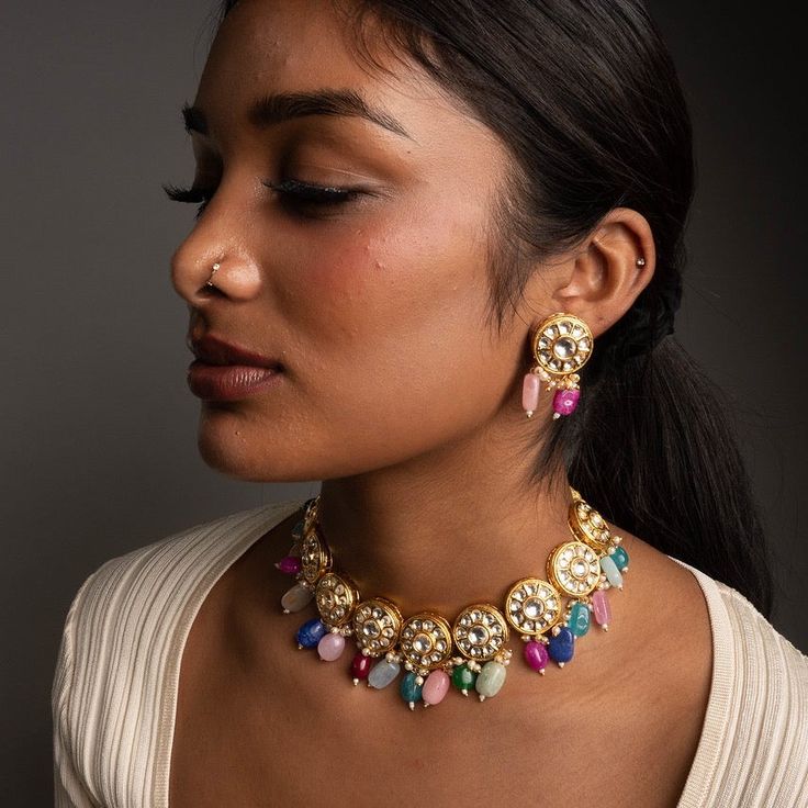 Inspired by the pastel colors of spring, our Kanali Jewelry Set will bring a lovely array of colors to your look. Featuring unique stones, and Kundan on Gold-Plating this dainty set is the perfect add to your collection. Specifications Materials used: kundan, Stones, Gold-Plating At Romikas, we pride ourselves on the craftsmanship and high quality of our jewelry, designed to enhance your natural beauty. Please contact us with any questions. Fusion Style Kundan Jewelry Sets With Gemstones, Fusion Kundan Gemstone Jewelry Sets, Elegant Multicolor Kundan Necklace, Multicolor Gemstone Jewelry Sets For Weddings, Multicolor Kundan Temple Jewelry Sets, Kundan Multi-stone Necklace For Celebration, Multi-stone Kundan Necklace For Celebrations, Fusion Style Multicolor Jewelry Sets For Diwali, Fusion Multicolor Jewelry Sets For Diwali