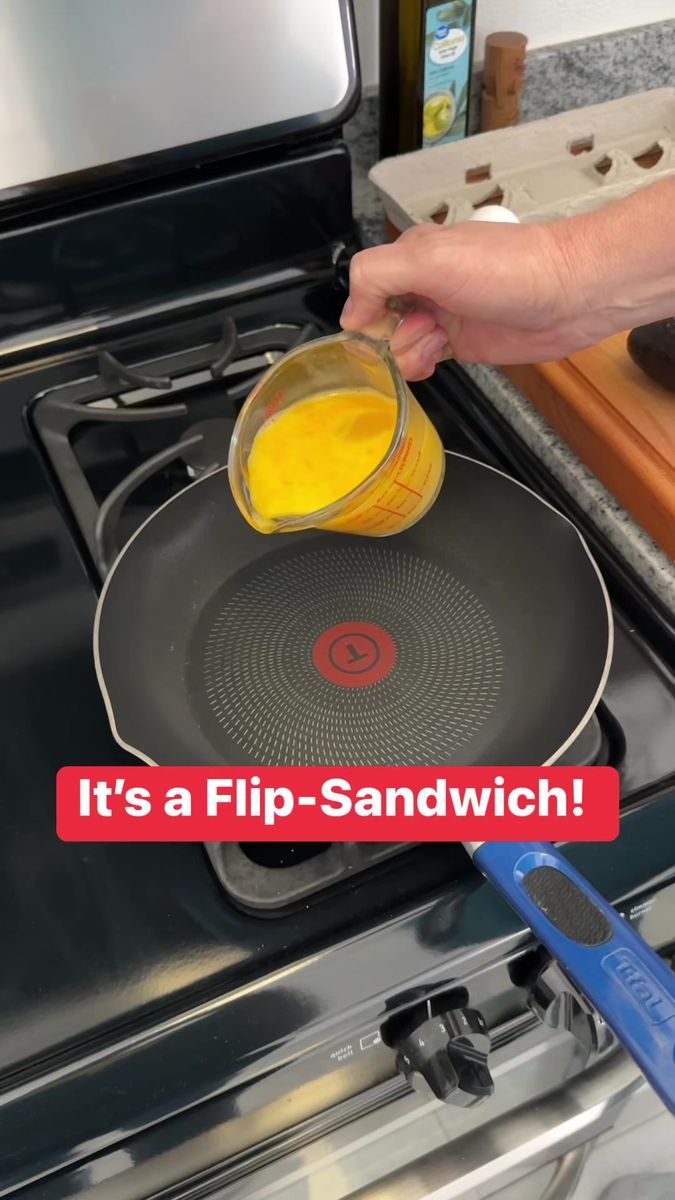 a person pouring orange juice into a frying pan on top of an electric stove