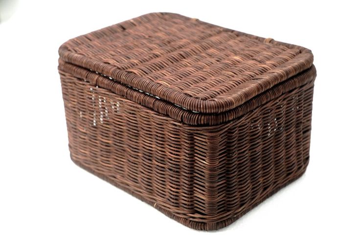 a brown wicker basket sitting on top of a white table