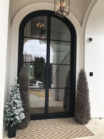 the front door is decorated with christmas trees