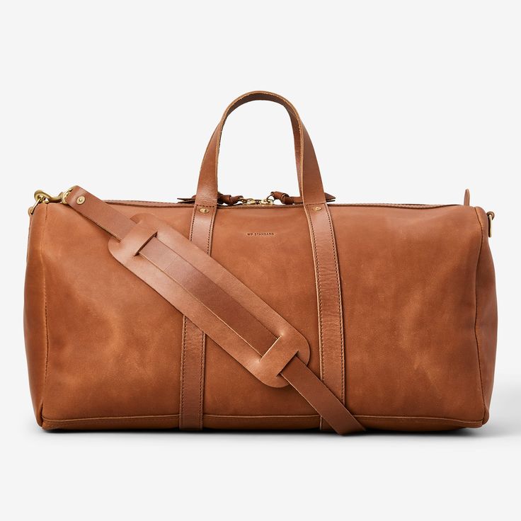 Live out all your Mad Men fantasies with the Pan Am Duffel Bag. Meticulously crafted from top-tier full-grain leather, this bag fuses classic aesthetics with lasting strength, ensuring it's your faithful travel companion for years to come. Designed to make your travels effortless, the adjustable strap offers comfortable carrying options, while its size adheres to airline carry-on regulations..View PanAm Duffle Bag by WP Standard on our site for more info. - The Bespoke Post store has the greatest gear from the world's best small brands. Free exchanges, easy returns and no commitments. Classic Leather-lined Luggage For Weekend Trips, Functional Leather Weekender Bag, Functional Leather Satchel For Weekend Trips, Leather Luggage For Weekend Trips, Modern Travel Bag In Vegetable Tanned Leather, Functional Brown Leather Duffle Bag, Classic Leather Satchel For Travel, Modern Vegetable Tanned Leather Travel Bag, Everyday Leather Satchel Functional Style