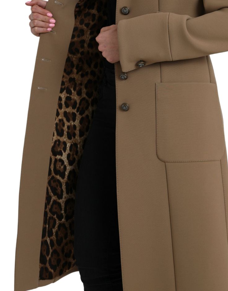 This brown Dolce & Gabbana coat boasts a button down design and is crafted from a blend of 53% polyester, 43% virgin wool, and 4% elastane. It also features a luxurious 92% silk and 8% elastane lining and is made in Italy.   Model: Coat jacket  Color: Brown  Material: 53% Polyester, 43% Virgin Wool, 4% Elastane  Lining: 92% Silk 8% Elastane  Button closure  Made in Italy Fall Business Outerwear With Covered Buttons, Tailored Brown Outerwear With Hidden Button Closure, Brown Tailored Outerwear With Hidden Button Closure, Wool Outerwear With Covered Buttons For Work, Tailored Brown Outerwear With Buttons, Tailored Wool Outerwear With Covered Buttons, Tailored Single Breasted Gabardine Outerwear, Business Wool Outerwear With Covered Buttons, Office Gabardine Outerwear With Button Closure