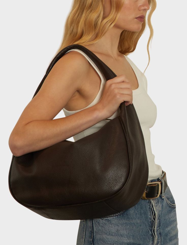 Product Details The Halo Day in grain dark brown features a sleek hobo bag form with a slender shape and sponged strap, constructed with comfort at its core. The minimal style of this shoulder bag comes with full zip closure suited for use as a work bag, travel bag or comfortable everyday bag. Renowned for its quality and style, for those who appreciate both form and function. This bag is exclusively handmade in the A-ESQUE Melbourne Atelier from the finest soft Italian aniline pebble grain leat Versatile Brown Smooth Grain Hobo Bag, Brown Smooth Grain Hobo Bag For On-the-go, Versatile Brown Hobo Bag With Smooth Grain, Designer Shoulder Bag, Brown Shoulder Bag, Minimal Style, Designer Shoulder Bags, Work Bag, Bag Travel