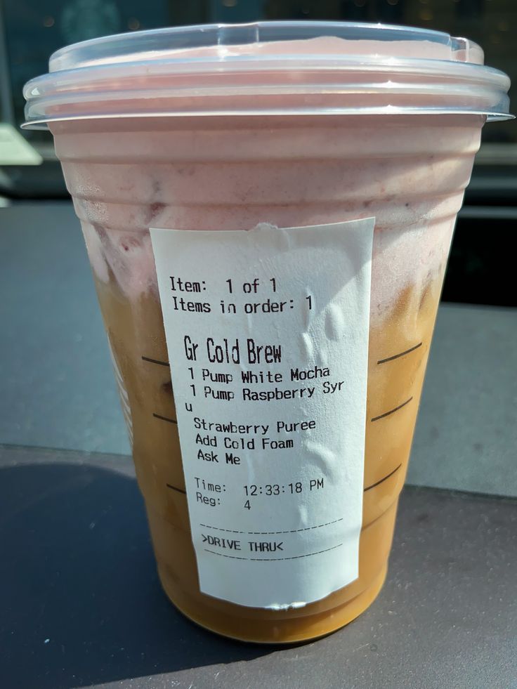 a plastic cup filled with liquid sitting on top of a table