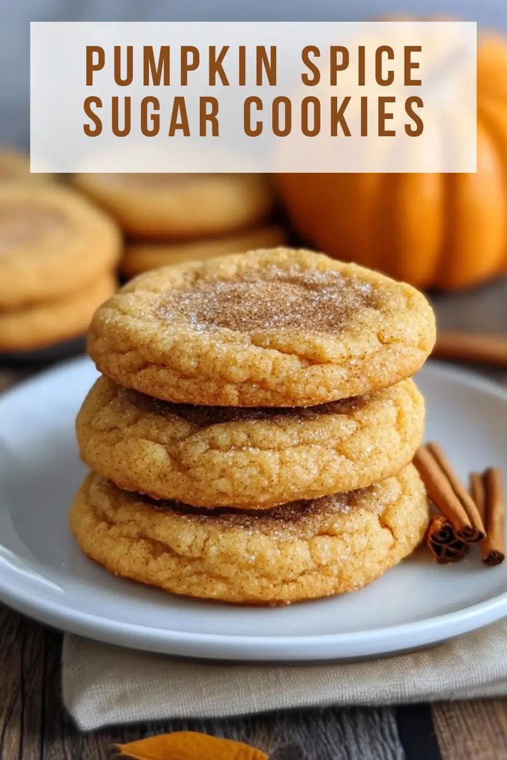 pumpkin spice sugar cookies on a white plate with cinnamon sticks and an orange pumpkin in the background