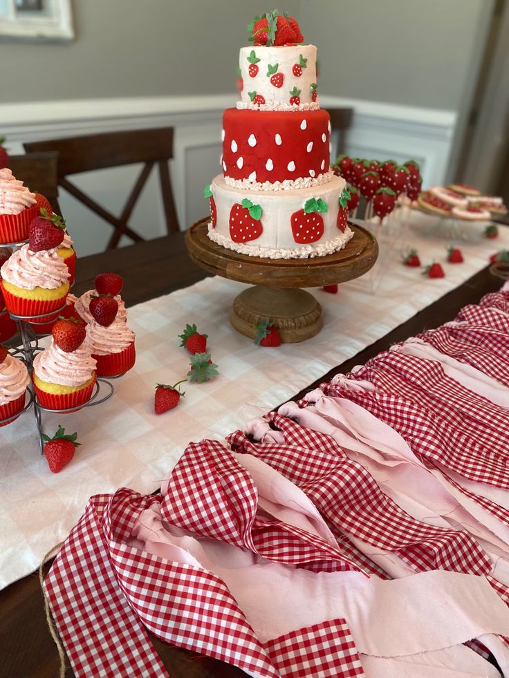 a table topped with lots of cakes and cupcakes