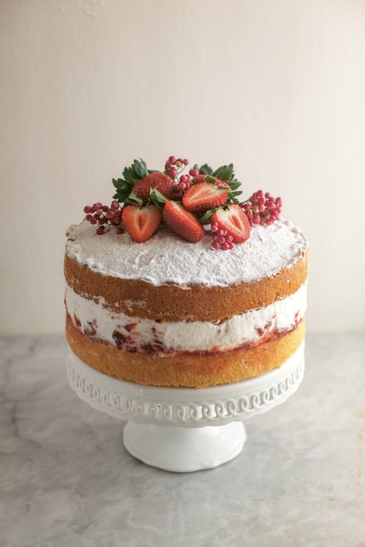 a cake with strawberries and berries on top