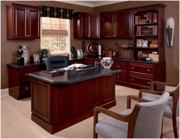 a large kitchen with wooden cabinets and black counter tops, along with a dog laying on the floor