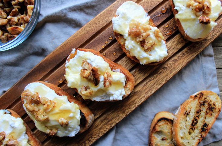 some food is laying out on a wooden board