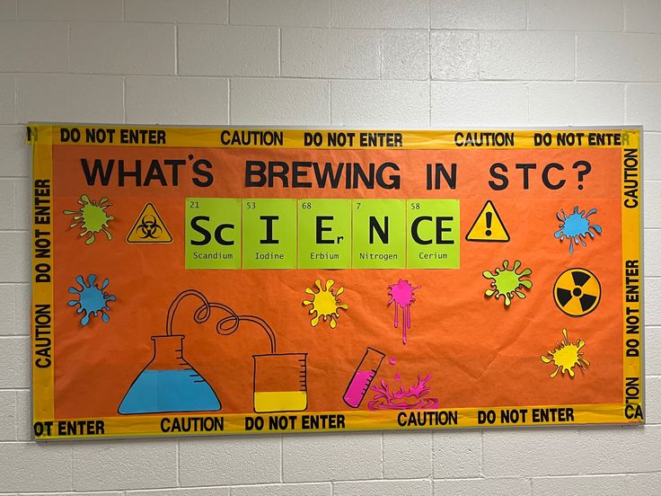 a bulletin board on the wall with science related writing and pictures around it that says what's brewing in stc?