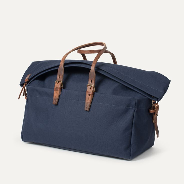 Cabine Travel bag - Navy Blue | Bleu de chauffe Casual Luggage With Adjustable Strap For Overnight Trips, Casual Rectangular Luggage With Leather Handles, Classic Blue Bag With Top Carry Handle, Classic Blue Bags With Top Carry Handle, Shoulder Bag With Top Carry Handle For Overnight Trips, Navy Tote Bag With Top Carry Handle, Blue Casual Travel Bag With Large Capacity, Casual Blue Travel Bag With Large Capacity, Navy Double Handle Bag With Top Carry