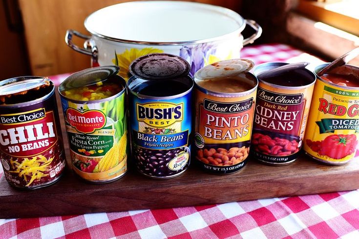 an assortment of canned foods on a wooden tray