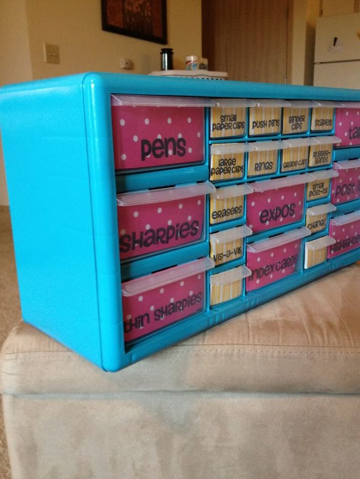 a blue and pink toy storage unit on top of a couch