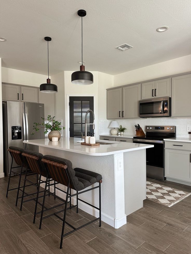 a kitchen with an island and three stools