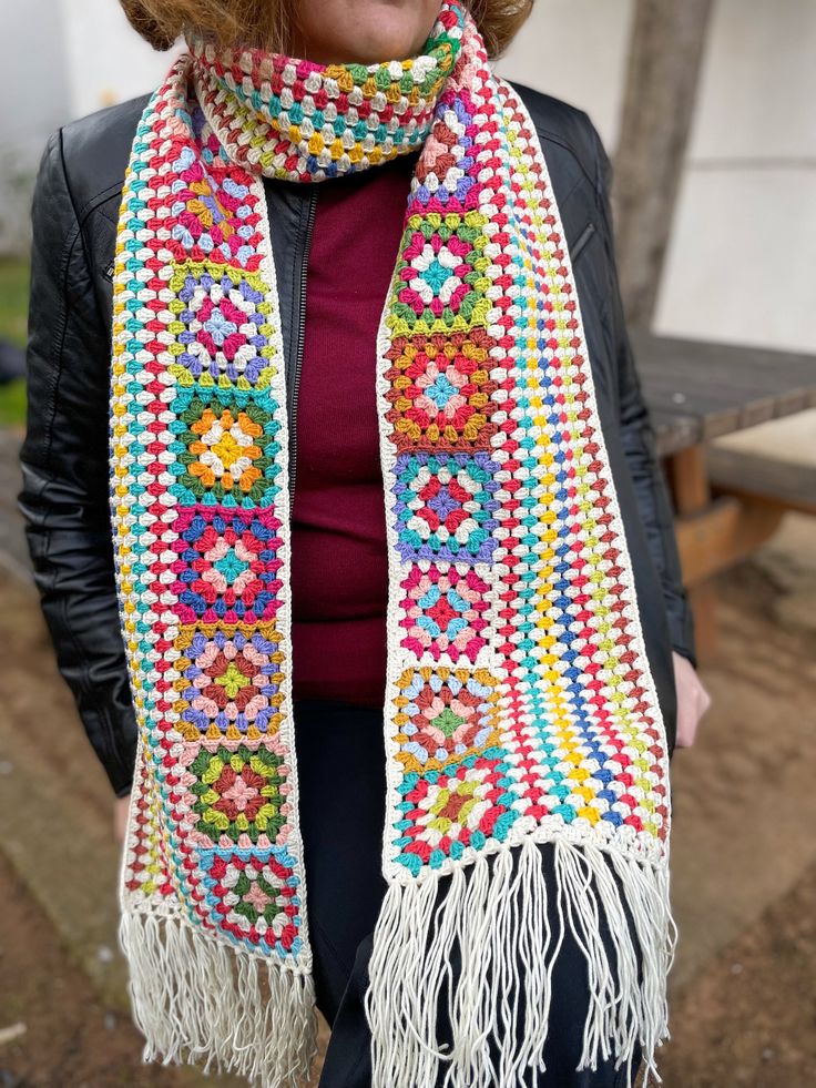 a woman wearing a colorful crocheted scarf