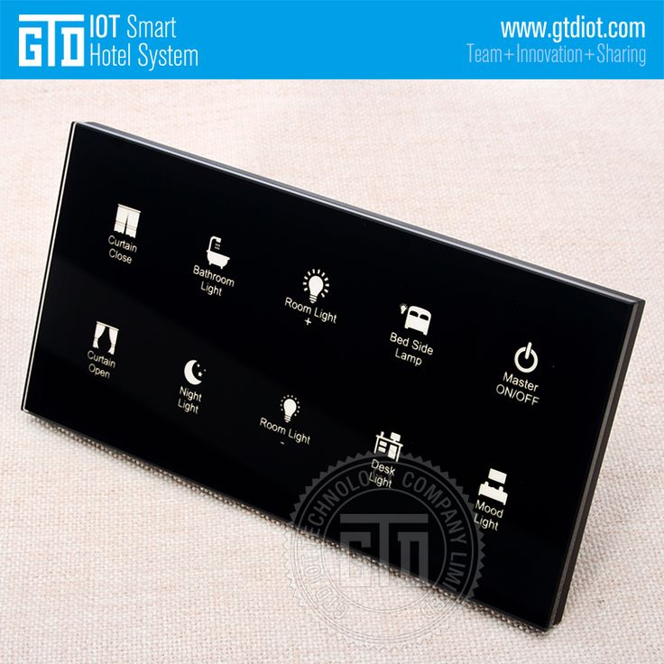 a close up of a black electronic device on a white surface with the words iot smart hotel system below it