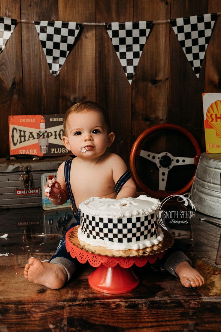 a baby sitting in front of a cake