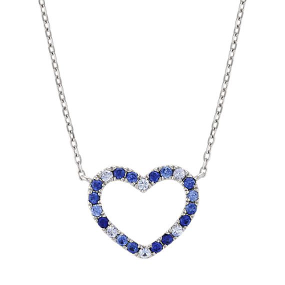 This fabulous multi-colored blue sapphire heart necklace crafted from quality sterling silver features 22 round multi-colored sapphires  at approximately .38 carat total weight  alternating in hues of blue around the heart-shaped design.  The heart measures approximately 1/2 of an inch long by a little over 1/2 of an inch wide. The design hangs from a matching 18-inch cable chain that allows for adjustment at 16 inches. Sapphire Heart Necklace, Baguette Diamond Necklace, Floating Diamond Necklace, Baguette Necklace, Heart Necklace Diamond, Platinum Jewelry, Necklace Craft, Minimal Jewelry, Solitaire Pendant