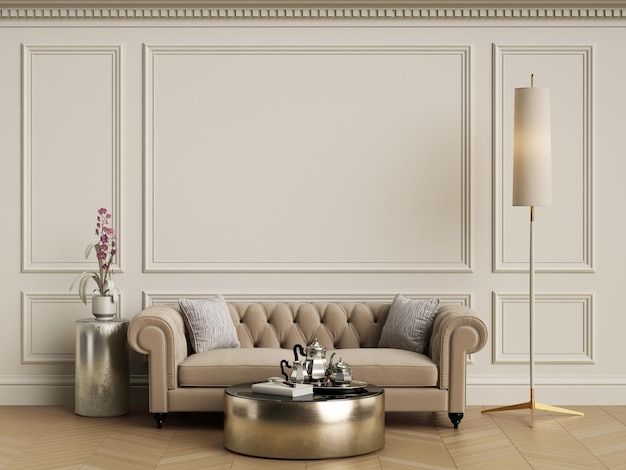 a living room with a couch, coffee table and vases on the floor in front of a white wall