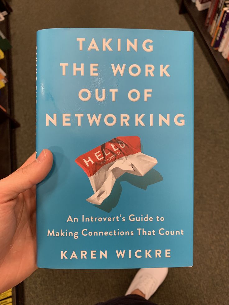 the book taking the work out of networking is being held up by someone's hand