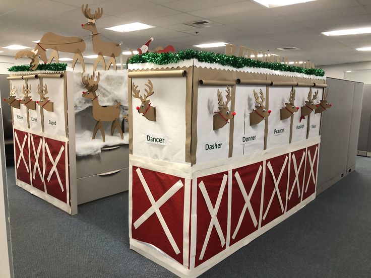 an office cubicle decorated for christmas with reindeer decorations