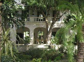 the house is surrounded by trees and plants