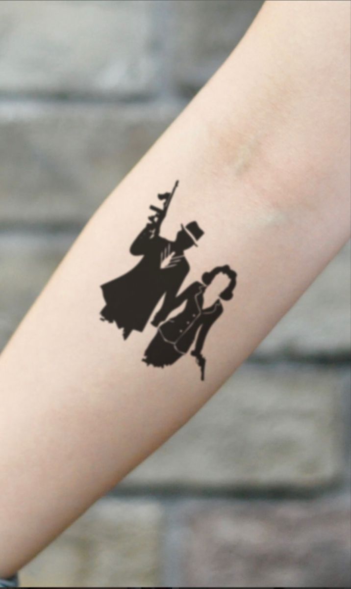 a woman's arm with a black and white silhouette of a wizard on it