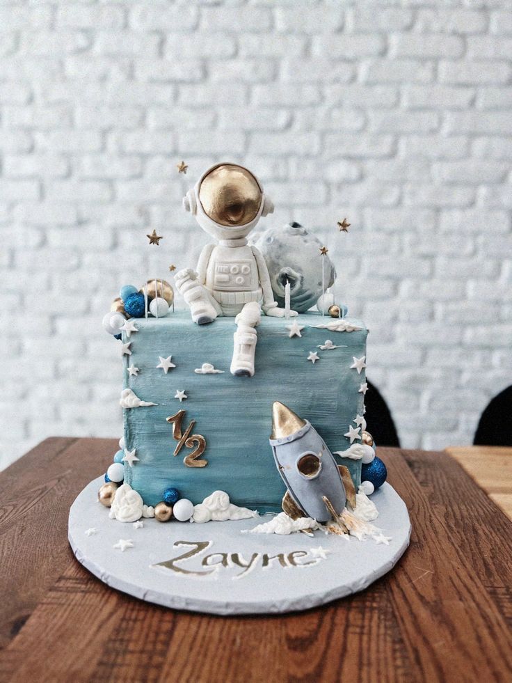 a cake with an astronaut sitting on top of it