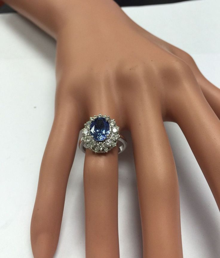 4.75 Carats Natural Very Nice Looking Tanzanite and Diamond 14K Solid White Gold Ring Suggested Replacement Value: $8,000.00 Total Natural Oval Cut Tanzanite Weight is: 3.50 Carats Tanzanite Measures: 9.00 x 7.00mm Natural Round Diamonds Weight: 1.25 Carats (color G-H / Clarity SI1-SI2) Ring total weight: 5.8g Disclaimer: all weights, measurements and colors are approximate and may vary slightly from the listed dimensions or as seen in the image. All pictures are magnified to show the smallest o Formal Platinum Gemstones Fine Jewelry, Formal Oval Diamond Gemstones, Elegant Brilliant Cut Gemstone For Anniversary, Fine Jewelry Platinum Gemstones For Formal Occasions, Oval Diamond Gemstones For Formal Occasions, Collectible Sapphire Ring With Center Stone In Platinum, Formal Round Cut Platinum Gemstones, Exquisite Formal Round Cut Gemstones, Elegant Platinum Gemstones For Anniversary